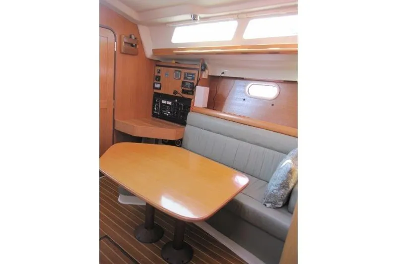 Sassy Cat Yacht Photos Pics Interior of 2004 Catalina 350 MkII sailboat with dining area and navigation panel.