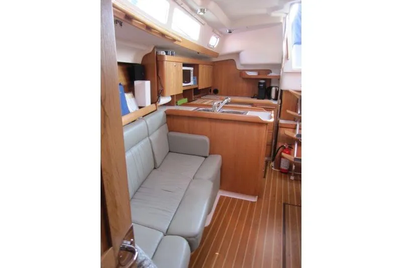 Sassy Cat Yacht Photos Pics Interior of 2004 Catalina 350 MkII sailboat with wood finish and cozy seating area.