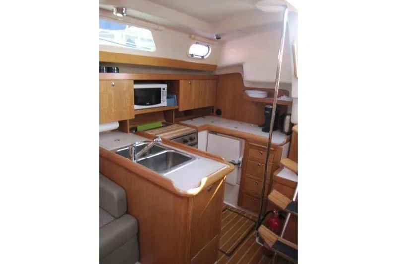Sassy Cat Yacht Photos Pics Interior of 2004 Catalina 350 MkII yacht featuring a compact kitchen area.