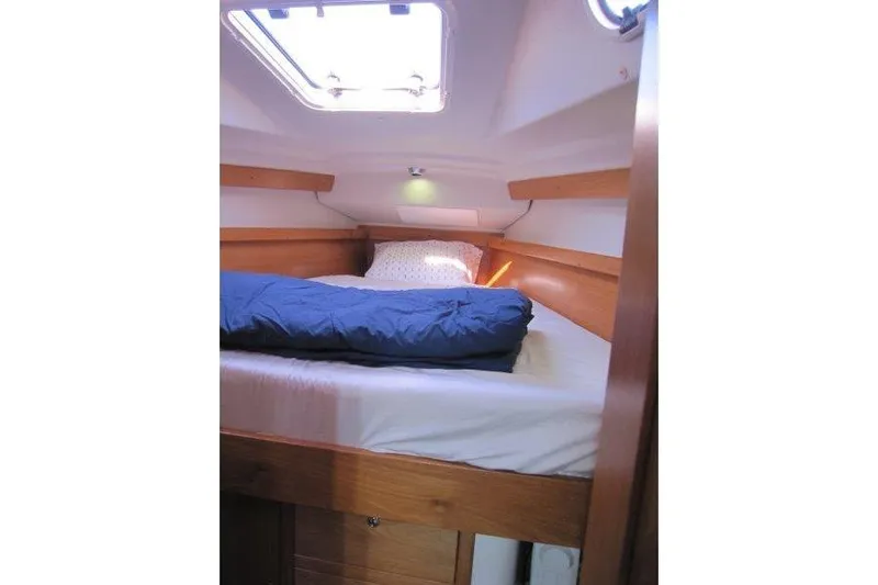 Sassy Cat Yacht Photos Pics Cozy cabin interior of 2004 Catalina 350 MkII sailboat with bedding and natural light.