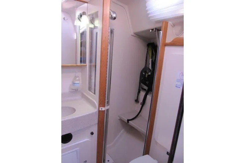 Sassy Cat Yacht Photos Pics 2004 Catalina 350 MkII yacht bathroom with sink, mirror, and shower area.
