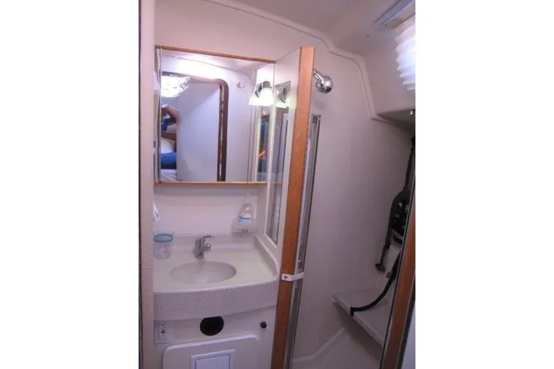 Sassy Cat Yacht Photos Pics Catalina 350 MkII 2004 yacht bathroom with sink, mirror, and shower area.