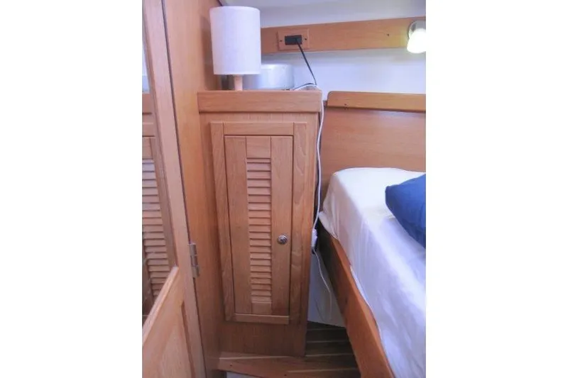 Sassy Cat Yacht Photos Pics Interior of 2004 Catalina 350 MkII yacht with wooden cabinet and bed.