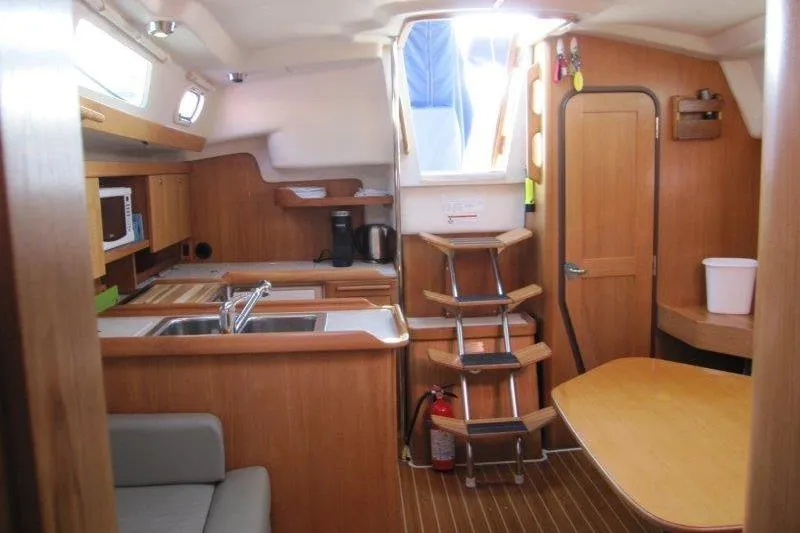 Sassy Cat Yacht Photos Pics Interior of a 2004 Catalina 350 MkII sailboat with wooden cabinetry and compact kitchen.