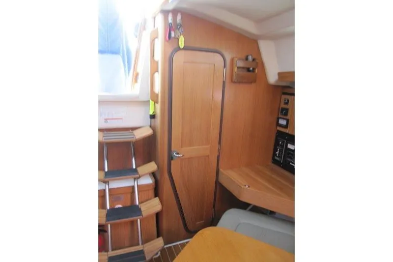 Sassy Cat Yacht Photos Pics Interior of 2004 Catalina 350 MkII sailboat with wooden door and steps.