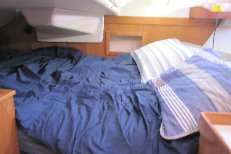 Sassy Cat Yacht Photos Pics Cozy cabin interior of a 2004 Catalina 350 MkII sailboat with blue bedding.