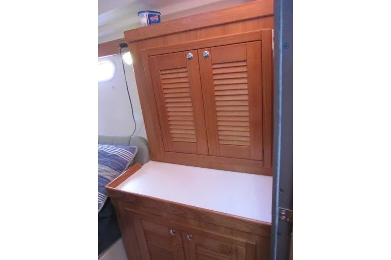 Sassy Cat Yacht Photos Pics 2004 Catalina 350 MkII interior with wooden cabinet and white countertop.