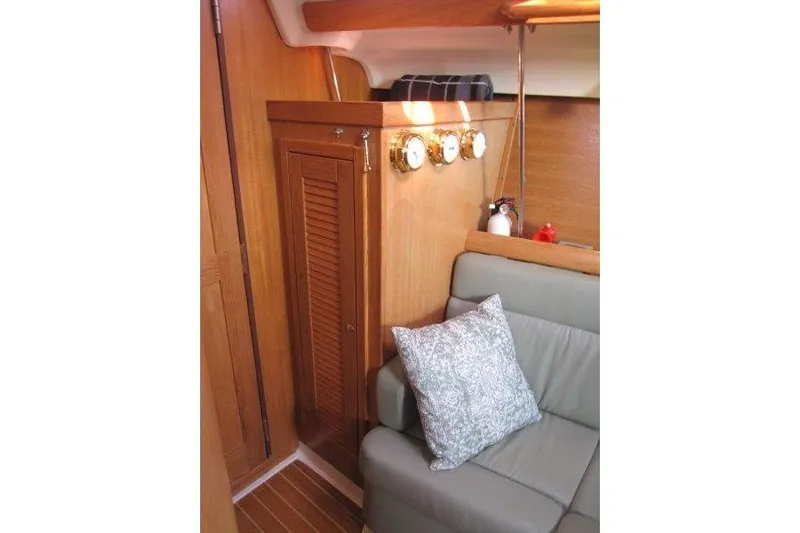 Sassy Cat Yacht Photos Pics Interior of 2004 Catalina 350 MkII sailboat with wood paneling and cushioned seating.