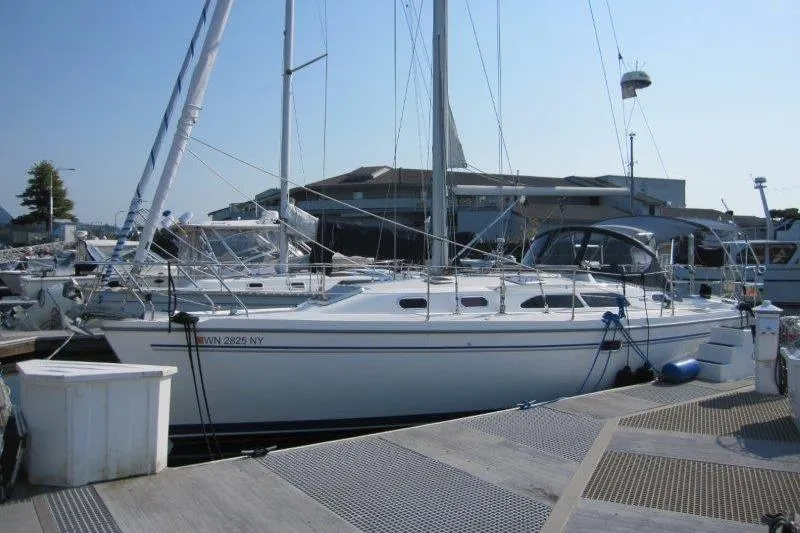Sassy Cat Yacht Photos Pics 2004 Catalina 350 MkII sailboat docked at a marina on a sunny day.
