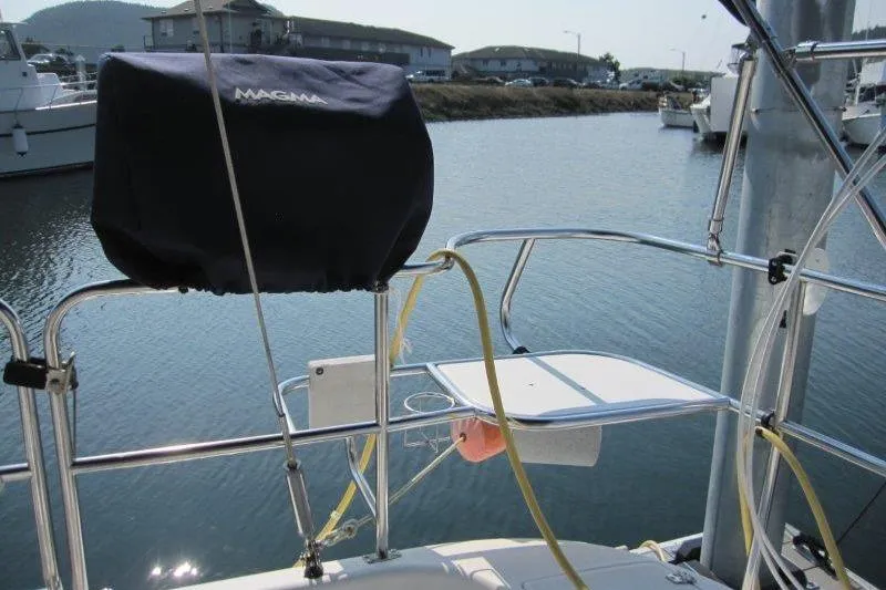 Sassy Cat Yacht Photos Pics Catalina 350 MkII 2004 sailboat stern with Magma grill, docked in marina.