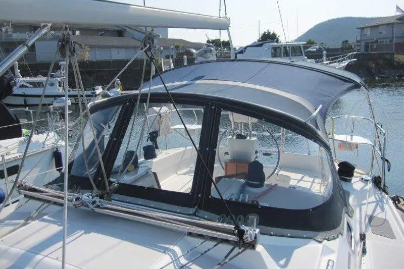 Sassy Cat Yacht Photos Pics 2004 Catalina 350 MkII sailboat with blue canopy docked in marina.