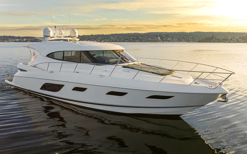 Ohana Yacht Photos Pics 2017 Riviera Sport Cruiser yacht on calm water at sunset.