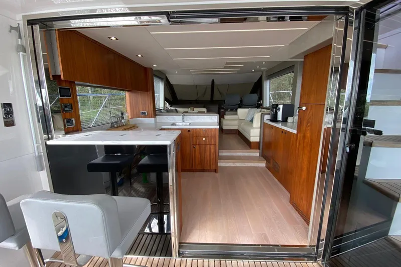  Yacht Photos Pics Luxurious interior of 2017 Sunseeker Manhattan 52 yacht with modern kitchen and seating area.