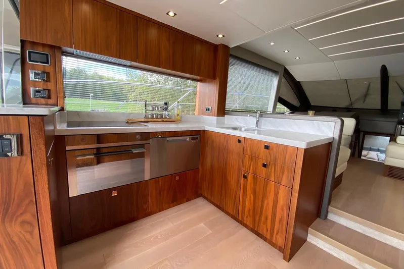  Yacht Photos Pics Luxurious kitchen interior of 2017 Sunseeker Manhattan 52 yacht with modern wood cabinetry.