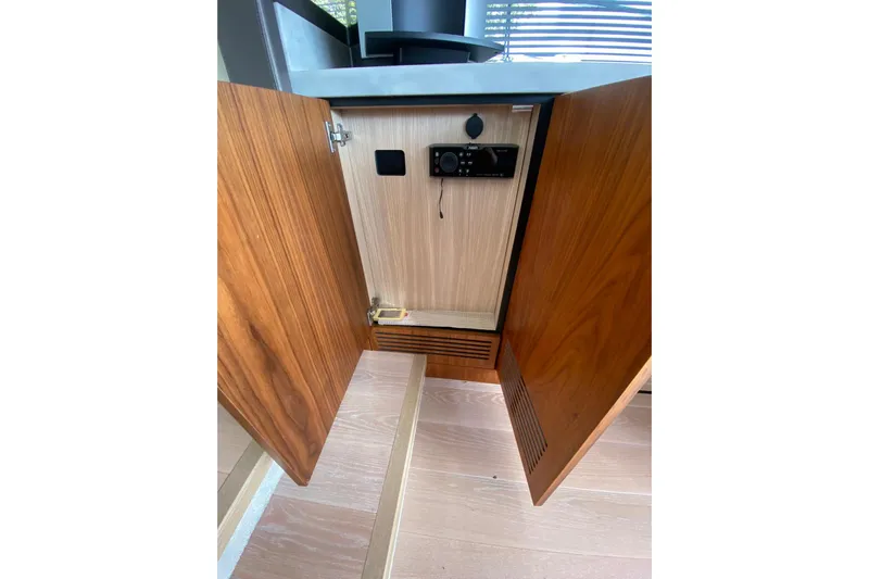  Yacht Photos Pics Open cabinet on 2017 Sunseeker Manhattan 52 yacht, showcasing interior storage space.