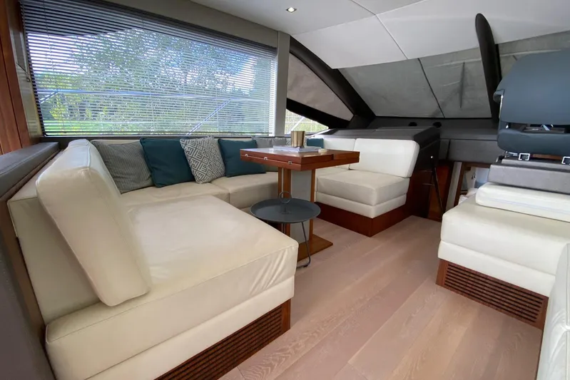  Yacht Photos Pics Luxurious interior of 2017 Sunseeker Manhattan 52 yacht with elegant seating and table.