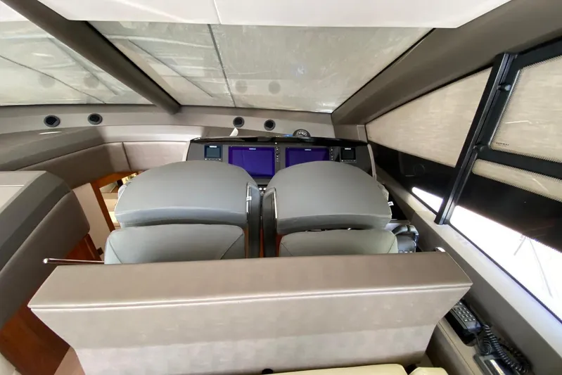  Yacht Photos Pics Interior helm of 2017 Sunseeker Manhattan 52 yacht with modern controls and seating.