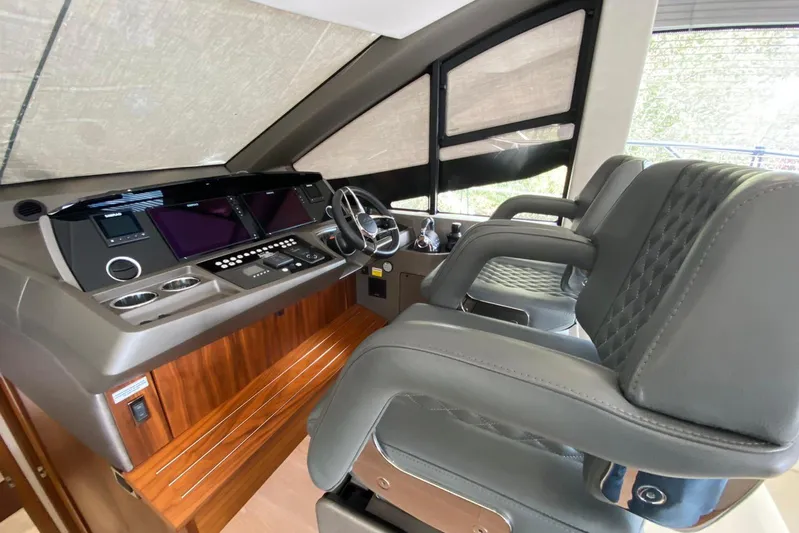  Yacht Photos Pics Interior helm of 2017 Sunseeker Manhattan 52 yacht with modern controls and seating.