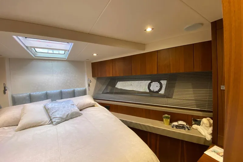  Yacht Photos Pics Luxurious cabin interior of 2017 Sunseeker Manhattan 52 yacht with elegant wood finishes.