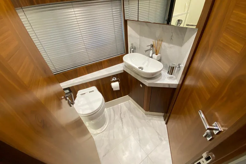 Yacht Photos Pics Luxurious bathroom in 2017 Sunseeker Manhattan 52 yacht with modern fixtures and wood accents.
