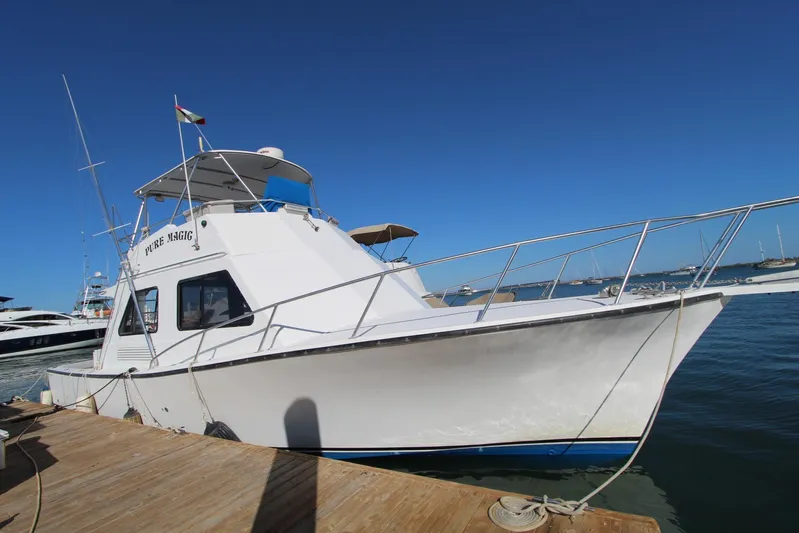 Pure Magic Yacht Photos Pics 2006 Island Hopper Sportfisher boat docked under clear blue sky.
