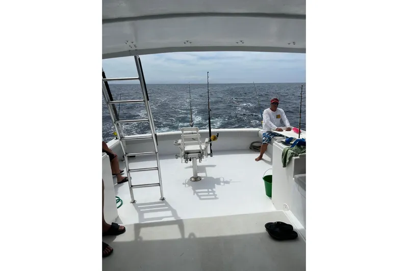 Pure Magic Yacht Photos Pics 2006 Island Hopper Sportfisher boat with fishing gear and ocean view.