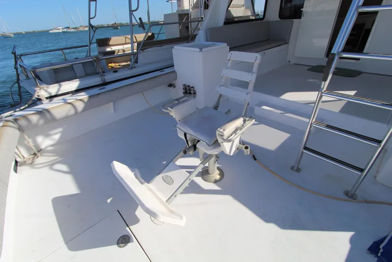 Pure Magic Yacht Photos Pics 2006 Island Hopper Sportfisher boat deck with fishing chair and ocean view.