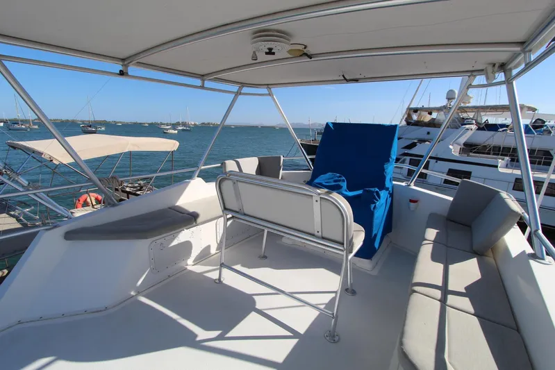 Pure Magic Yacht Photos Pics 2006 Island Hopper Sportfisher boat deck with seating, overlooking marina and ocean.