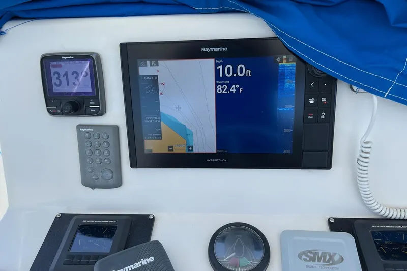 Pure Magic Yacht Photos Pics Island Hopper Sportfisher 2006 dashboard with Raymarine navigation and depth display.
