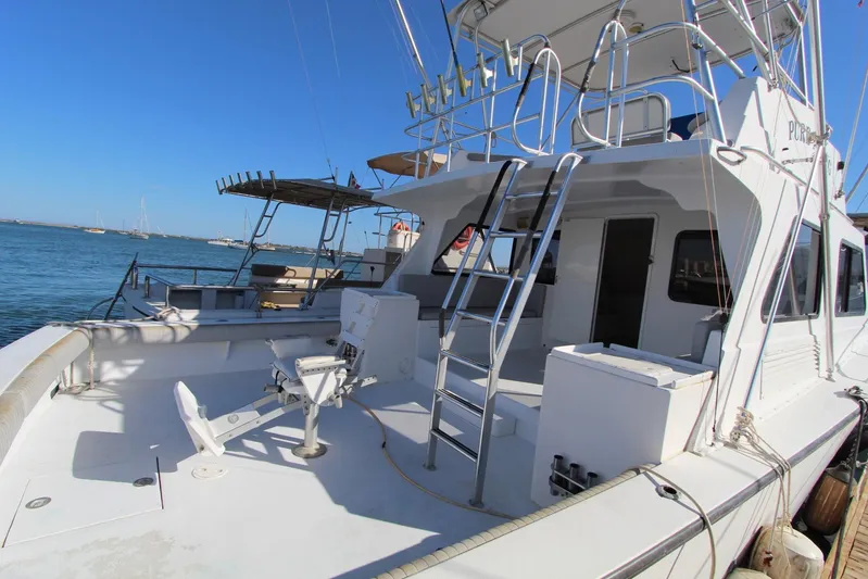 Pure Magic Yacht Photos Pics 2006 Island Hopper Sportfisher boat docked, featuring spacious deck and fishing equipment.