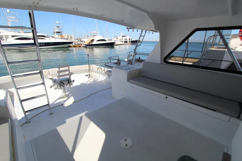 Pure Magic Yacht Photos Pics Interior view of 2006 Island Hopper Sportfisher boat with seating and ladder, docked at marina.