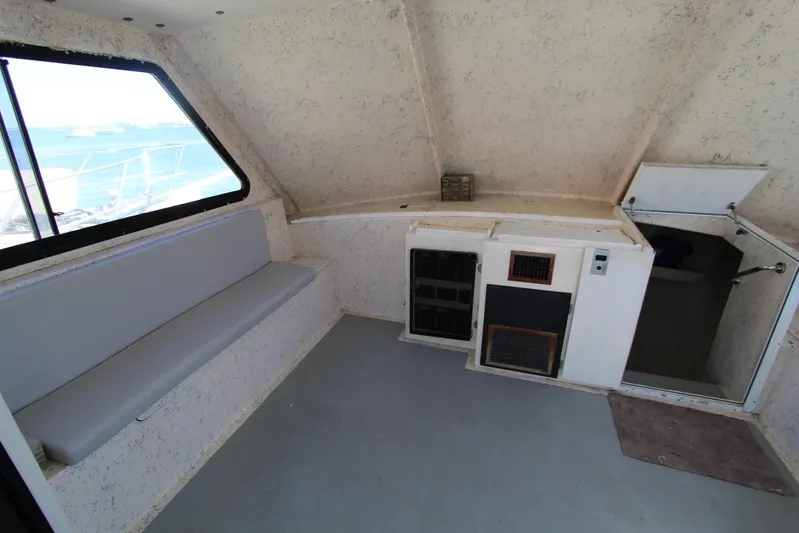 Pure Magic Yacht Photos Pics Interior of 2006 Island Hopper Sportfisher boat with seating and control panel.