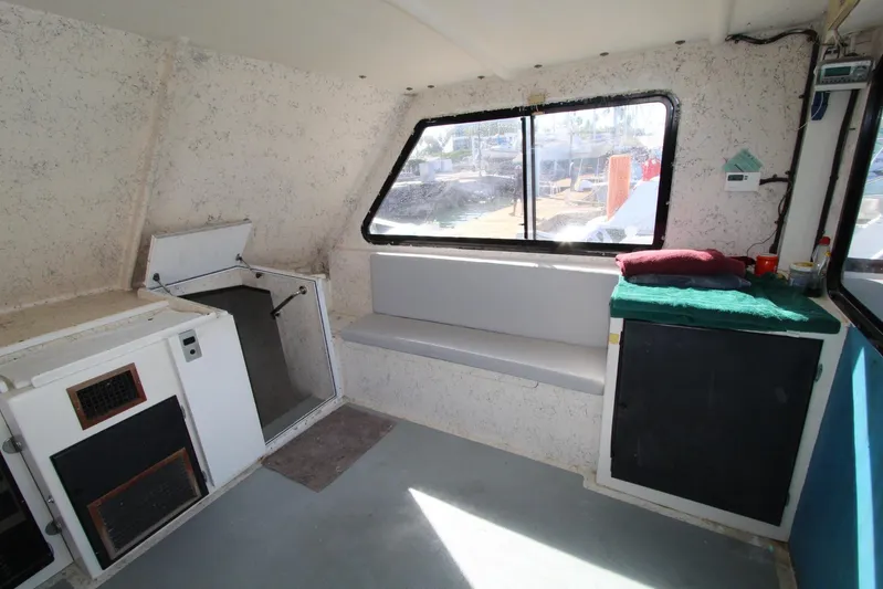 Pure Magic Yacht Photos Pics Interior of 2006 Island Hopper Sportfisher boat with seating and storage compartments.