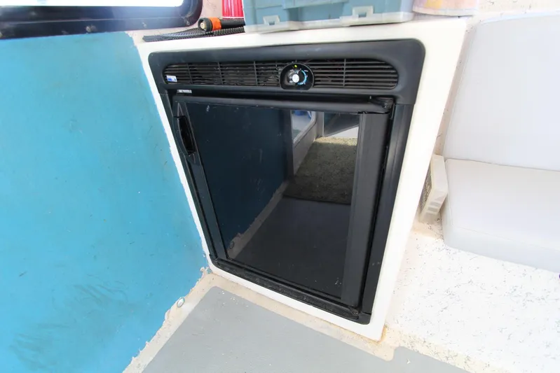 Pure Magic Yacht Photos Pics 2006 Island Hopper Sportfisher interior with a compact black refrigerator.
