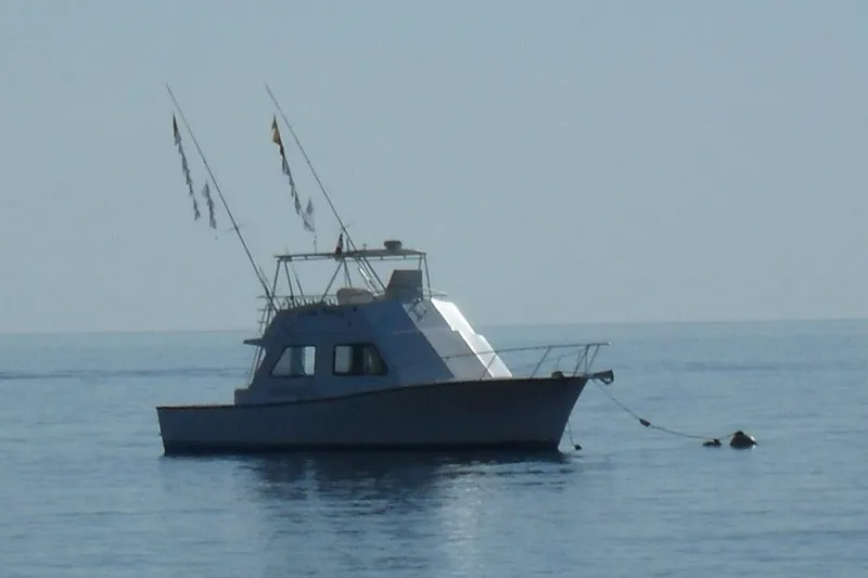 Pure Magic Yacht Photos Pics 2006 Island Hopper Sportfisher boat anchored on calm sea.