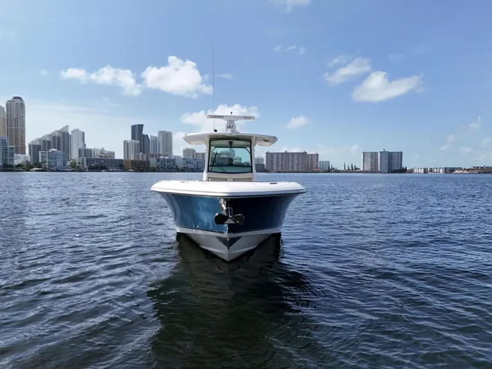  Yacht Photos Pics 2017 Boston Whaler 350 Outrage boat on water with city skyline background.