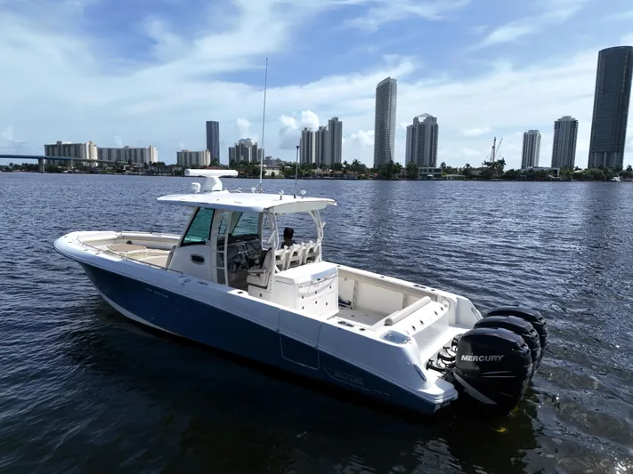  Yacht Photos Pics Boston Whaler 350 Outrage 2017 boat on water with city skyline background.