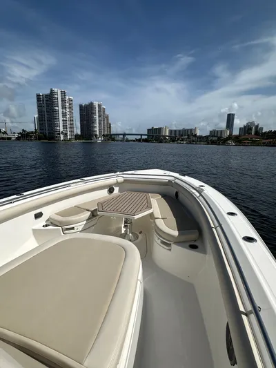  Yacht Photos Pics 2017 Boston Whaler 350 Outrage on water with city skyline in background.