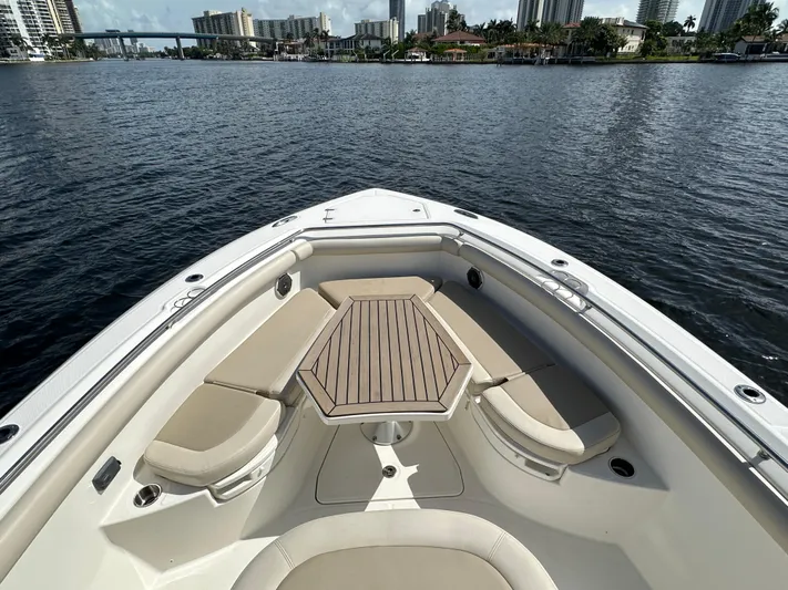  Yacht Photos Pics Boston Whaler 350 Outrage 2017 boat bow with seating and table on calm water.