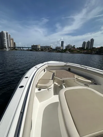  Yacht Photos Pics Boston Whaler 350 Outrage 2017 cruising on a scenic urban waterway.