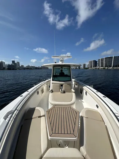  Yacht Photos Pics 2017 Boston Whaler 350 Outrage boat on water with city skyline.
