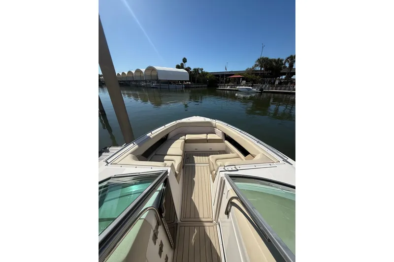  Yacht Photos Pics 2018 Regal 33 OBX boat with spacious seating, docked on a sunny day.