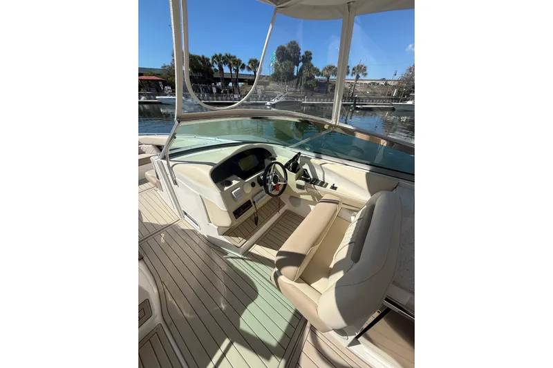 Yacht Photos Pics 2018 Regal 33 OBX boat helm with beige seating and waterfront view.