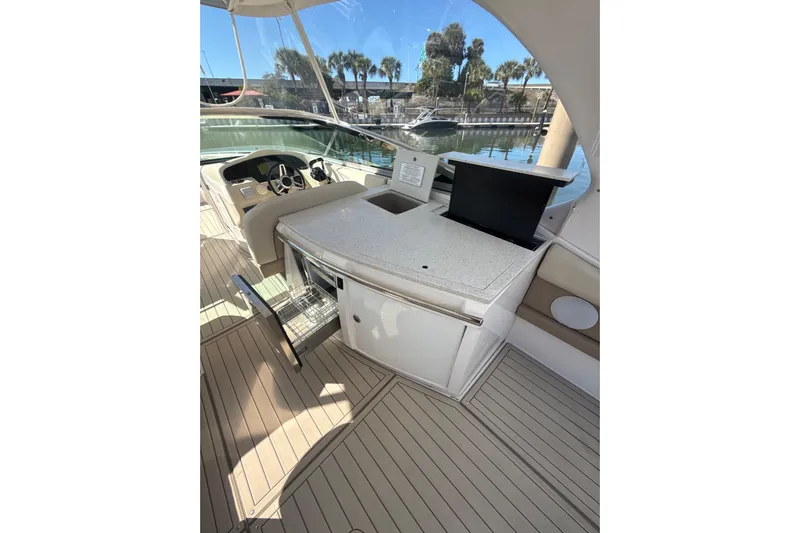  Yacht Photos Pics 2018 Regal 33 OBX boat interior with helm, seating, and open storage compartment.