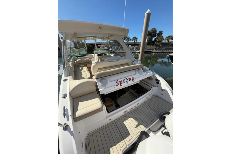  Yacht Photos Pics 2018 Regal 33 OBX boat with beige seating, docked at marina.