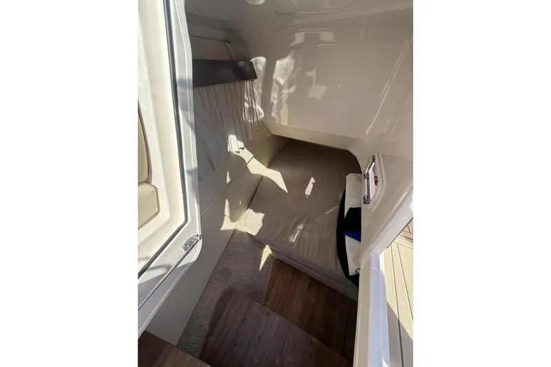  Yacht Photos Pics 2018 Regal 33 OBX cabin interior with cozy sleeping area and soft lighting.