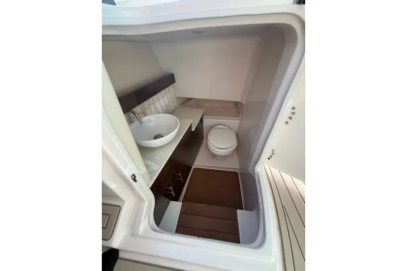  Yacht Photos Pics 2018 Regal 33 OBX boat bathroom with sink, toilet, and wooden flooring.