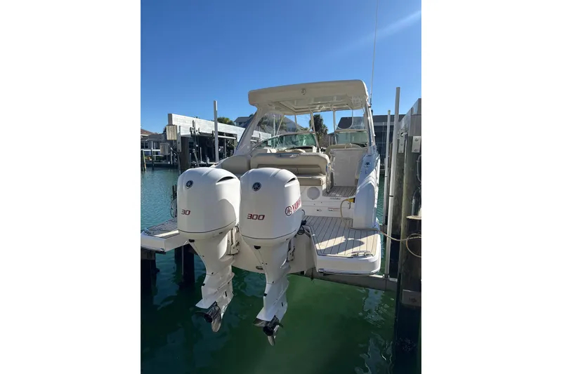  Yacht Photos Pics 2018 Regal 33 OBX boat with twin Yamaha 300 engines docked in sunny marina.