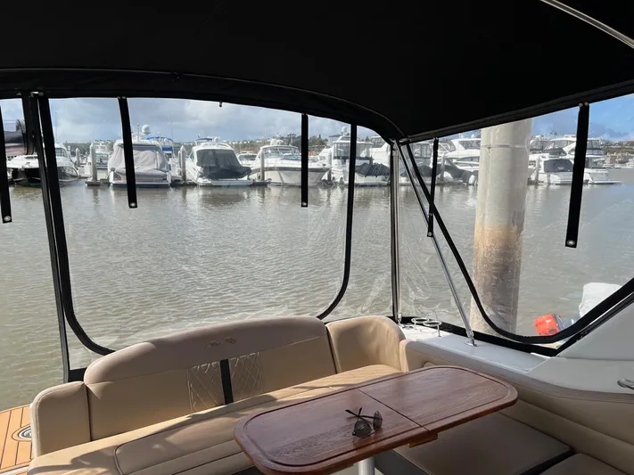  Yacht Photos Pics 2016 Sea Ray 310 Sundancer interior view at marina, featuring seating and table.