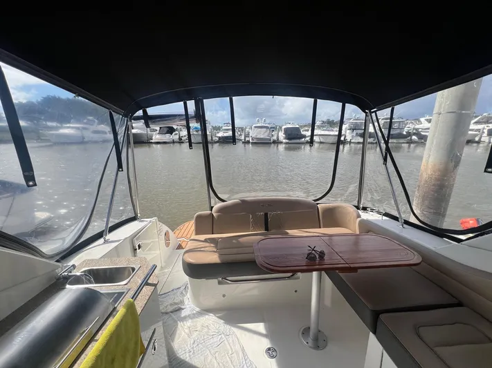  Yacht Photos Pics Interior view of 2016 Sea Ray 310 Sundancer boat with seating and table.